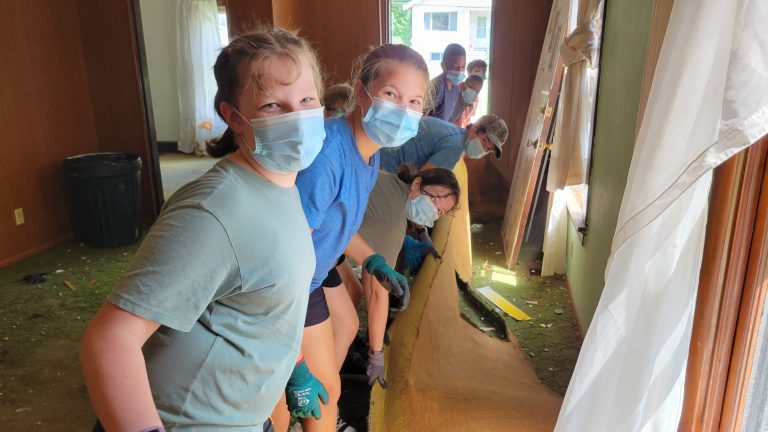 Young volunteers cleaning out a house